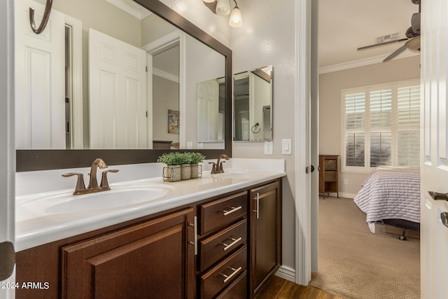 bathroom featuring vanity, ornamental molding, hardwood / wood-style floors, and ceiling fan