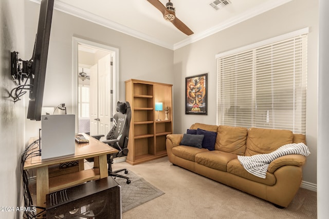 carpeted home office featuring ornamental molding and ceiling fan