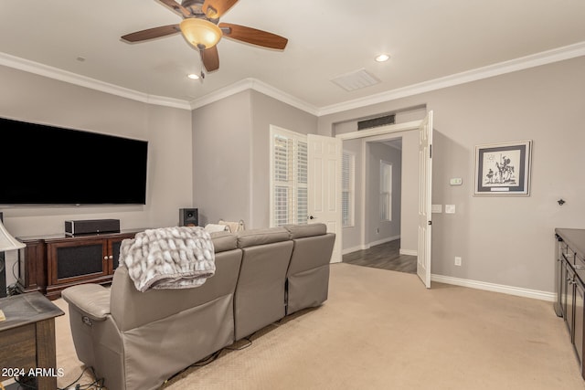 home theater featuring ornamental molding, light colored carpet, and ceiling fan