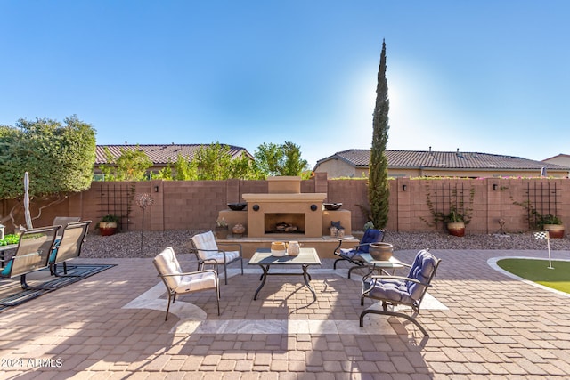 view of patio / terrace featuring exterior fireplace