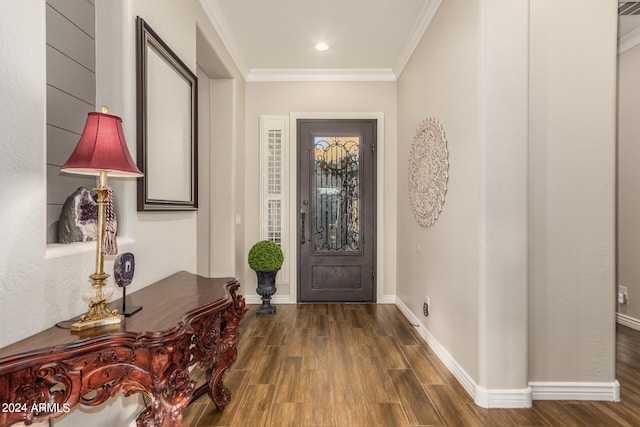 entrance foyer with ornamental molding and dark hardwood / wood-style floors