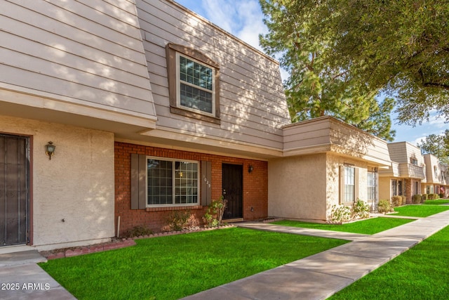 view of exterior entry with a yard