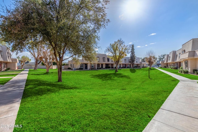 view of property's community with a yard