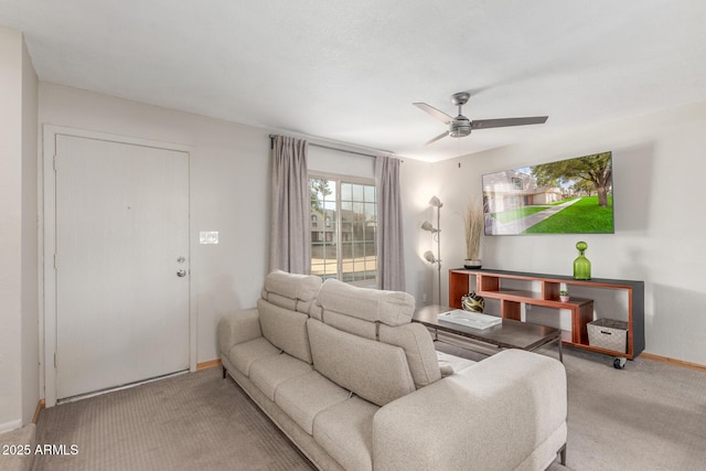 carpeted living room with ceiling fan