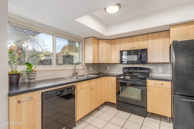 kitchen featuring sink, black appliances, light tile patterned floors, light brown cabinets, and backsplash