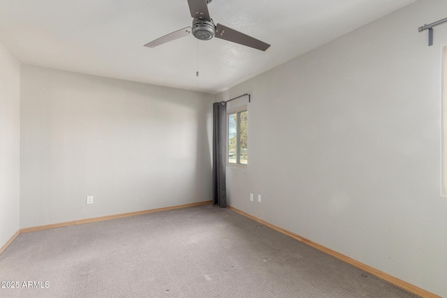 spare room with carpet floors and ceiling fan