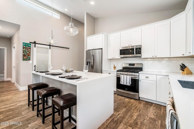 1005 E Weldon Ave, Phoenix, AZ 85014 - kitchen with stainless steel appliances, high vaulted ceiling, backsplash, wood finished floors, and a center island