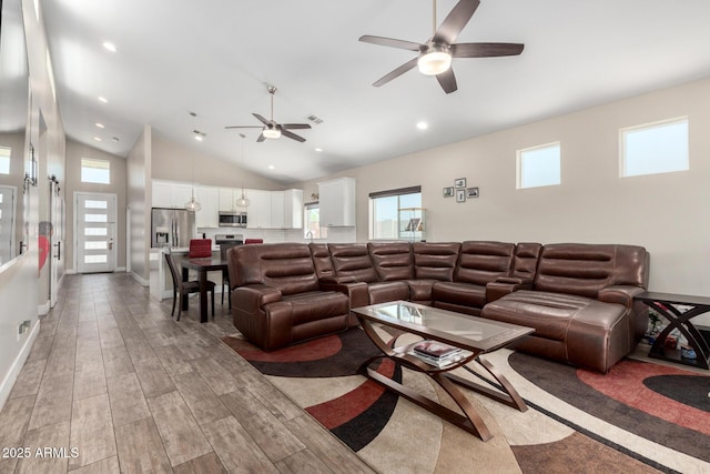 1005 E Weldon Ave, Phoenix, AZ 85014 - living room with a ceiling fan, light wood-style flooring, lofted ceiling, baseboards, and recessed lighting