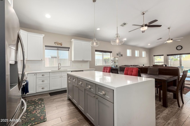 1005 E Weldon Ave, Phoenix, AZ 85014 - kitchen featuring stainless steel fridge with ice dispenser, a sink, wood finished floors, a ceiling fan, and vaulted ceiling