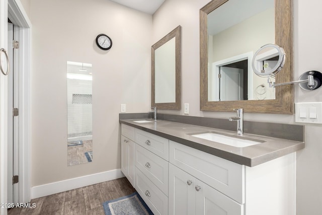 1005 E Weldon Ave, Phoenix, AZ 85014 - bathroom with double vanity, wood finished floors, and baseboards