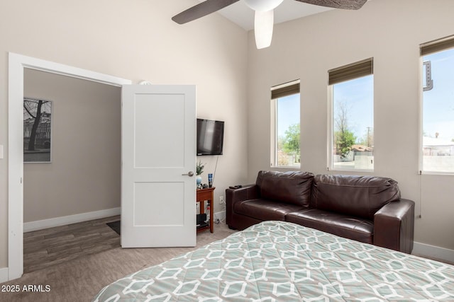 1005 E Weldon Ave, Phoenix, AZ 85014 - bedroom with baseboards, wood finished floors, and a ceiling fan
