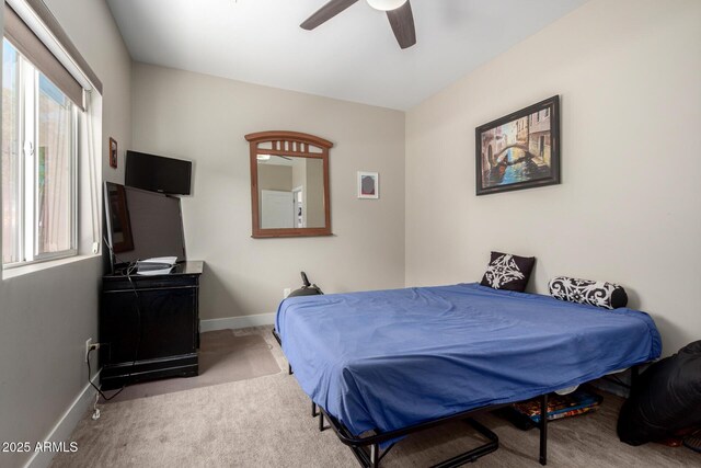 1005 E Weldon Ave, Phoenix, AZ 85014 - carpeted bedroom featuring multiple windows, baseboards, and ceiling fan