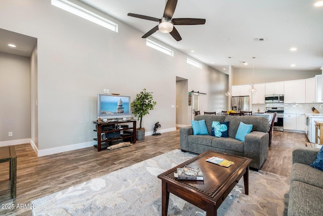 1005 E Weldon Ave, Phoenix, AZ 85014 - living area featuring ceiling fan, light wood-style floors, baseboards, recessed lighting, and high vaulted ceiling