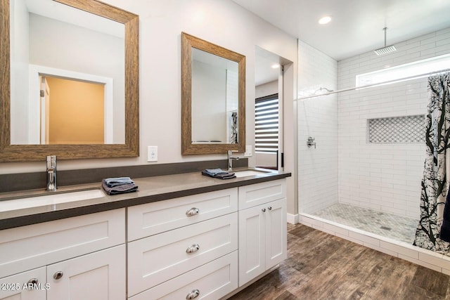 1005 E Weldon Ave, Phoenix, AZ 85014 - full bath featuring double vanity, a tile shower, wood finished floors, and recessed lighting