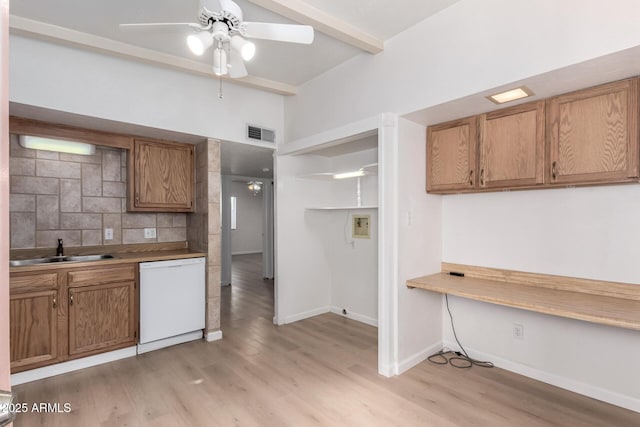 kitchen featuring built in desk, tasteful backsplash, sink, white dishwasher, and light hardwood / wood-style floors