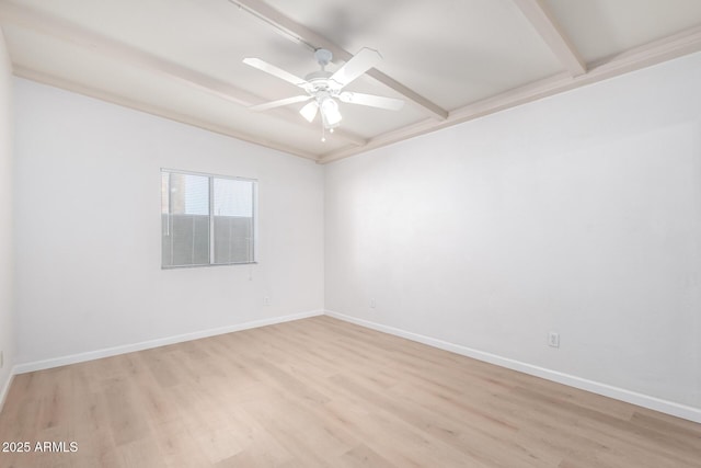 spare room featuring ceiling fan, light hardwood / wood-style floors, and beamed ceiling