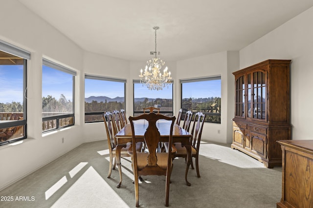 carpeted dining space with a mountain view and a notable chandelier