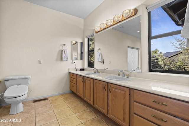 bathroom featuring tile patterned floors, vanity, and toilet