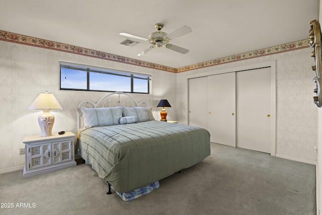 carpeted bedroom featuring ceiling fan and a closet