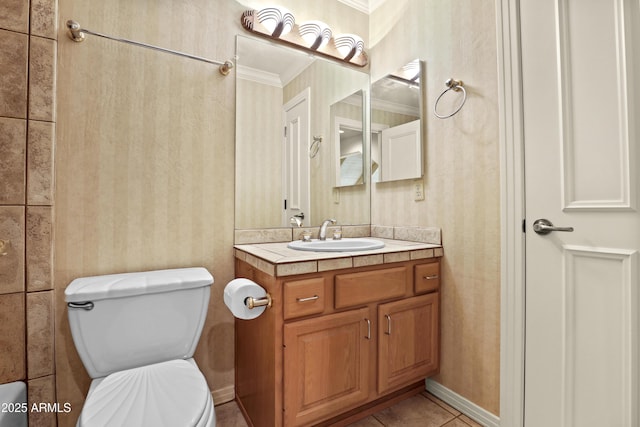 bathroom featuring tile patterned floors, vanity, toilet, and crown molding