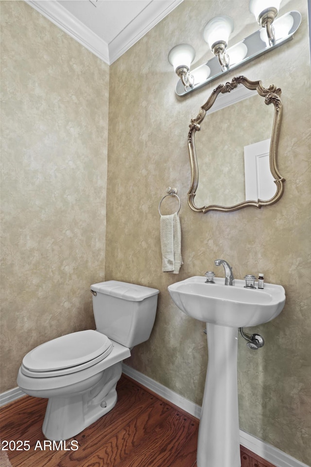 bathroom with toilet, wood-type flooring, and ornamental molding