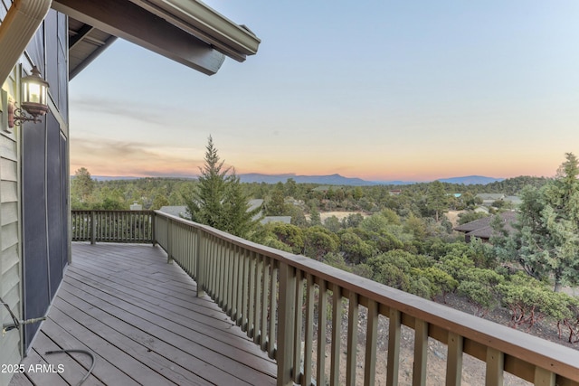 deck at dusk featuring a mountain view