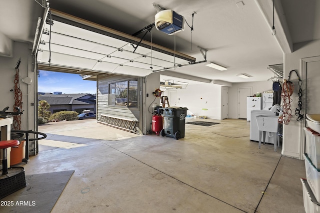 garage with white fridge and a garage door opener