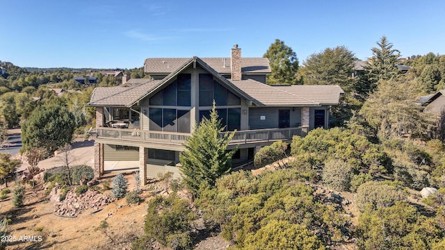 rear view of property with a balcony