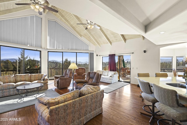 living room with beam ceiling, ceiling fan, sink, and dark wood-type flooring