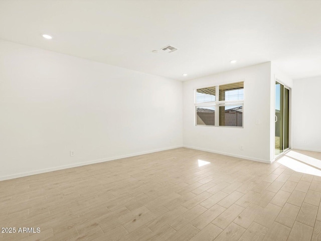 empty room with light hardwood / wood-style flooring