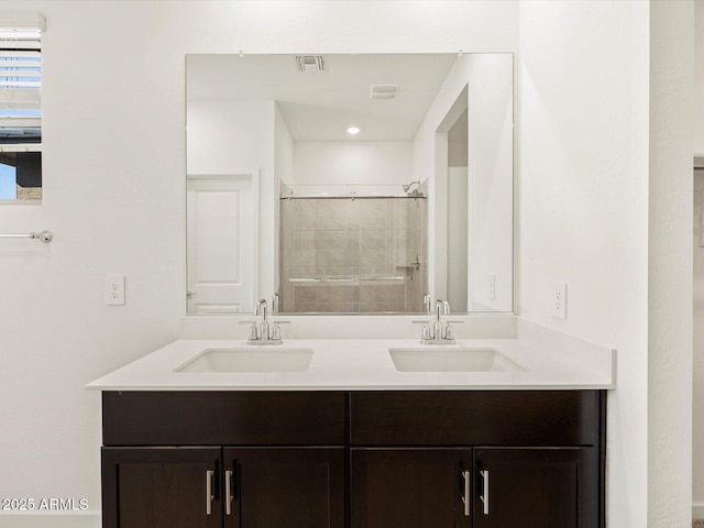 bathroom featuring vanity and a shower with door