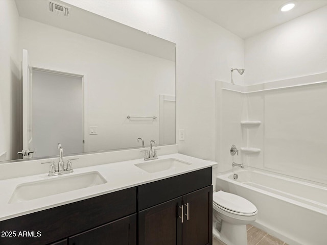 full bathroom featuring shower / washtub combination, vanity, and toilet