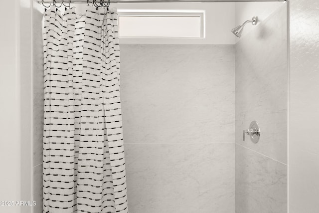 full bath featuring tiled shower