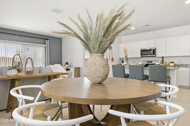 dining area with recessed lighting and visible vents