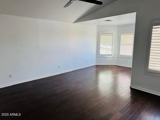 3502 W Belle Ave, San Tan Valley, AZ 85144 - spare room featuring vaulted ceiling, a ceiling fan, dark wood-style flooring, and baseboards