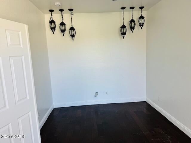 3502 W Belle Ave, San Tan Valley, AZ 85144 - unfurnished dining area featuring baseboards and dark wood-type flooring