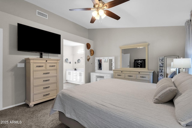 bedroom with ensuite bathroom, lofted ceiling, light colored carpet, and ceiling fan