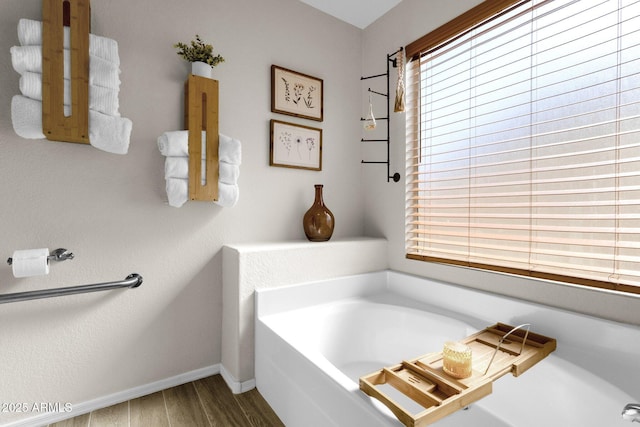 bathroom with hardwood / wood-style floors and a bathing tub