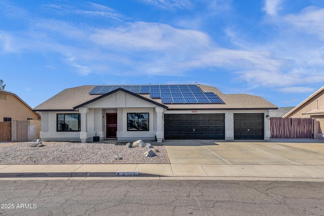 view of front facade featuring a garage and solar panels