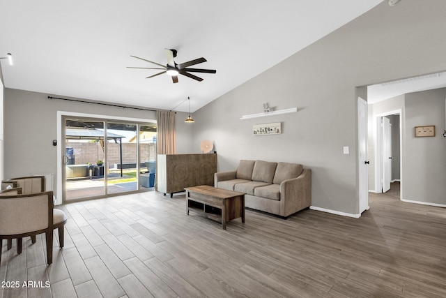 living room with hardwood / wood-style floors, high vaulted ceiling, and ceiling fan