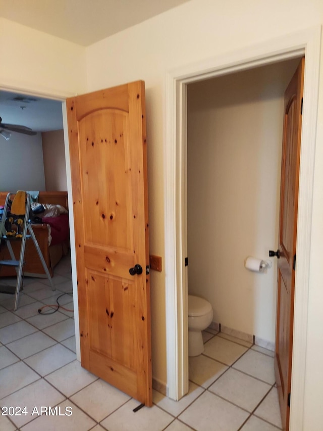 bathroom featuring toilet, tile patterned floors, and ceiling fan