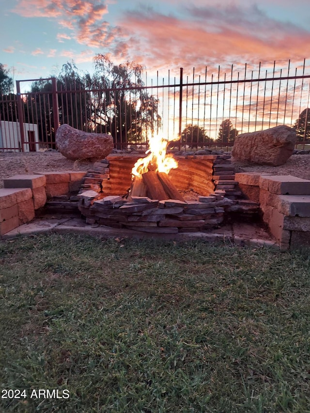 yard at dusk with a fire pit