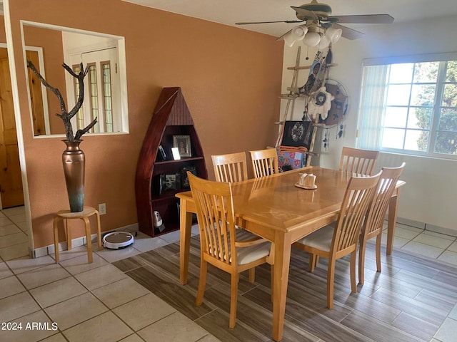 dining area featuring tile patterned flooring and ceiling fan