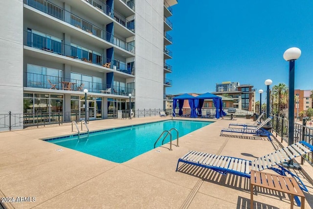 view of swimming pool with a gazebo and a patio