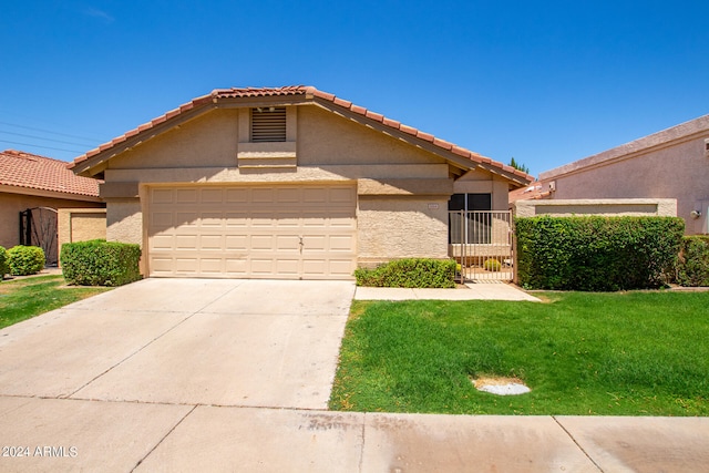 view of front of house featuring a garage and a front lawn