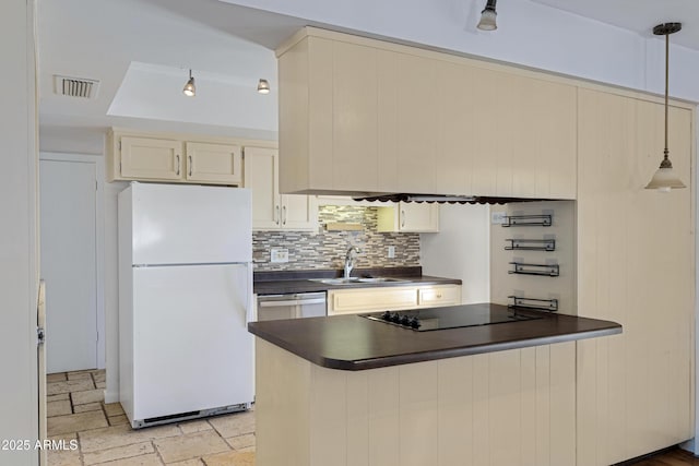 1215 E Geneva Dr, Tempe, AZ 85282 - kitchen with freestanding refrigerator, dark countertops, a sink, black electric cooktop, and backsplash