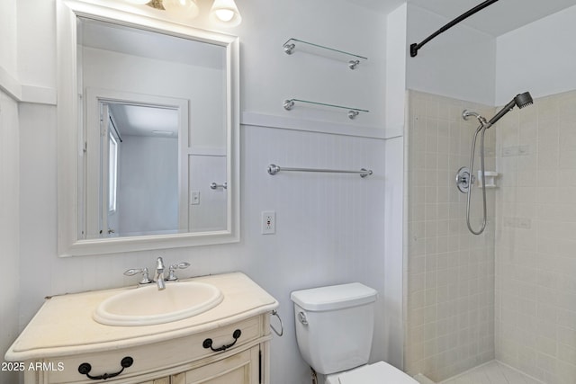 1215 E Geneva Dr, Tempe, AZ 85282 - full bathroom featuring toilet, tiled shower, vanity, and wainscoting