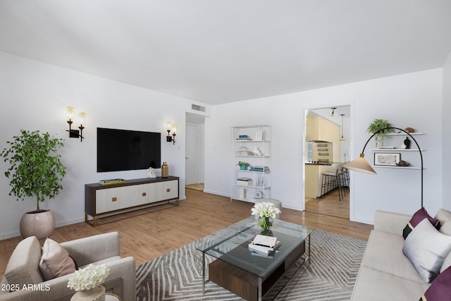 1215 E Geneva Dr, Tempe, AZ 85282 - living area featuring light wood-style flooring and baseboards