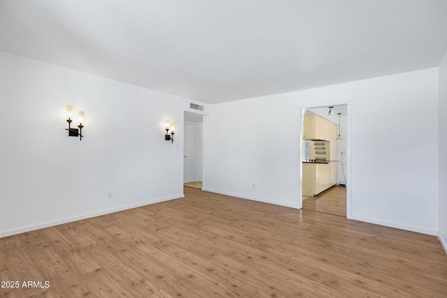 1215 E Geneva Dr, Tempe, AZ 85282 - empty room featuring light wood-style floors and baseboards