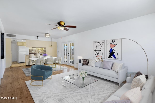 1215 E Geneva Dr, Tempe, AZ 85282 - living room with french doors, a ceiling fan, and light wood-style flooring